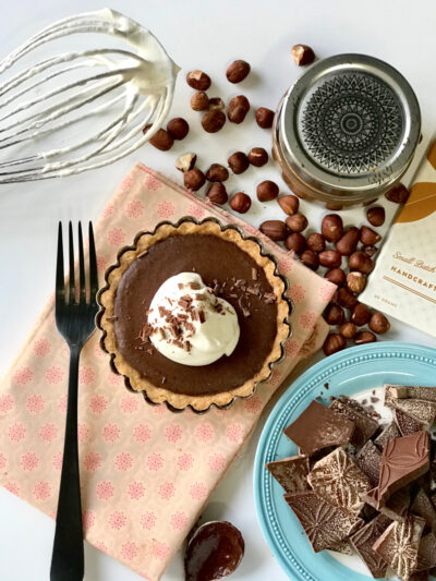 chocolate tart with hazelnuts and whipped cream