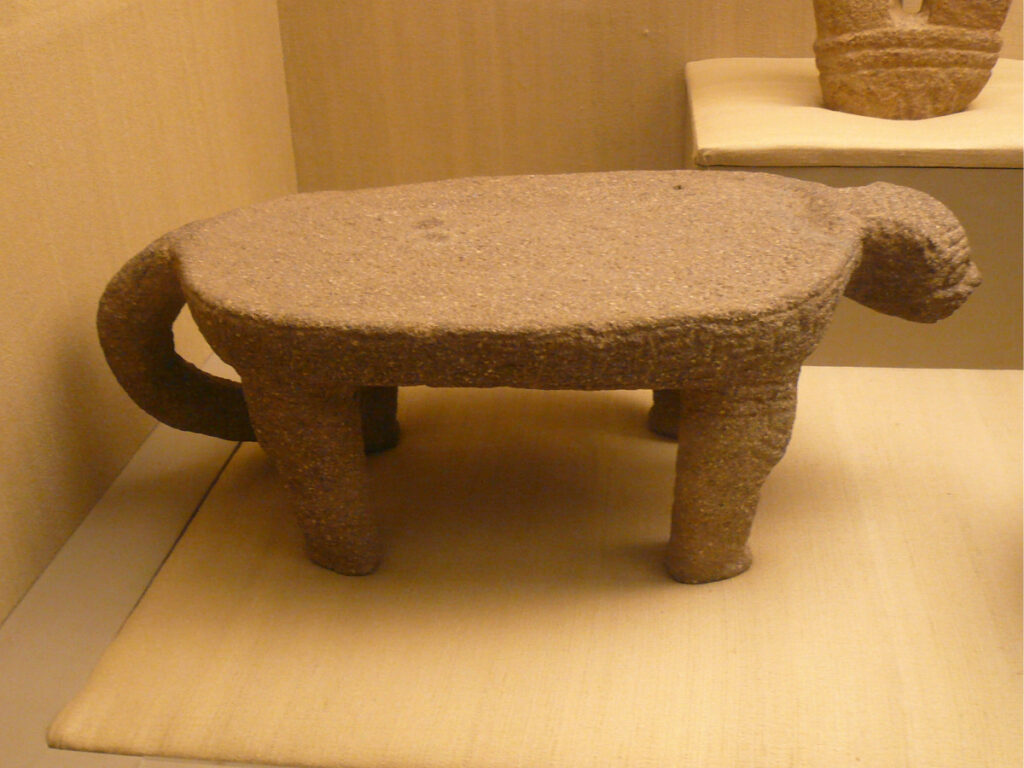 Metate in the shape of a monkey at a museum
