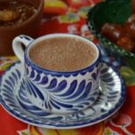 Mexican hot chocolate in a cup on a table