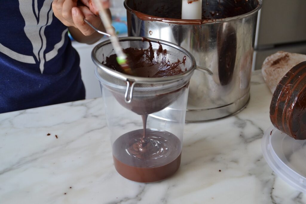 pouring chocolate through a sieve