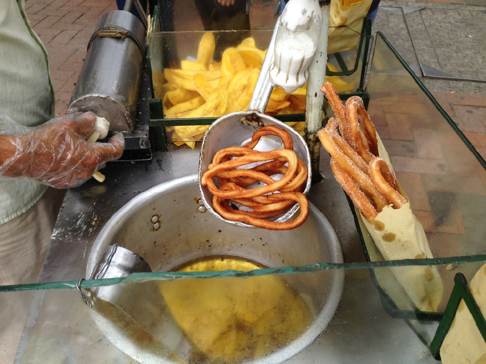man making churros in Colombia