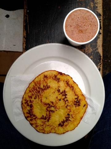 arepa colombia on a white plate with a hot chocolate
