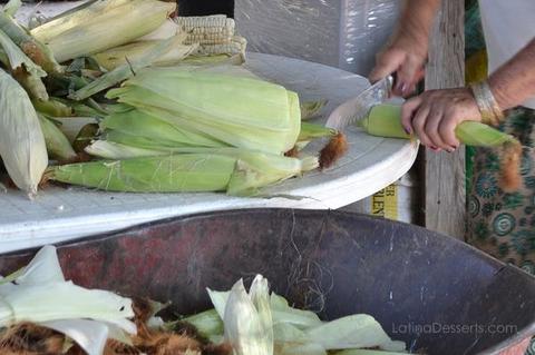 cutting the leaves from fresh corn 
