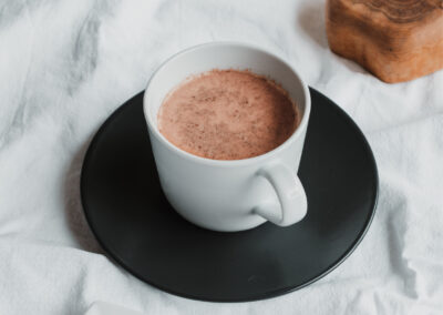 cup of hot chocolate in a white cup on a black plate