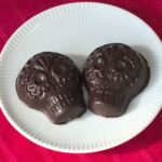 two chocolate skulls on a plate