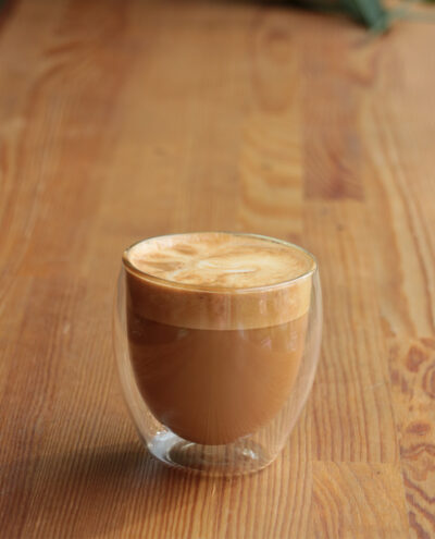 hot chocolate in a glass cup on a wooden table